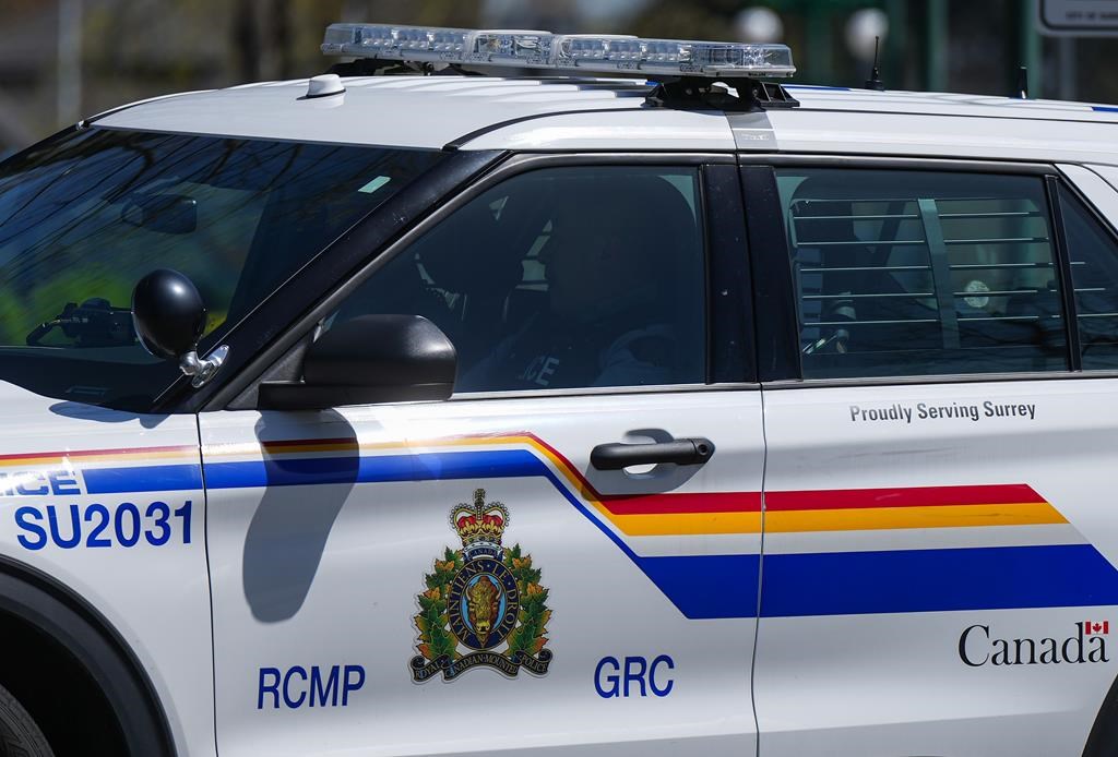 A Surrey RCMP officer drives a police vehicle in Surrey, B.C., on Friday, April 28, 2023. THE CANADIAN PRESS/Darryl Dyck.